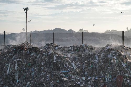 Garbage strewn across a landfill site.